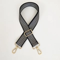 Detail of adjustable black and white herringbone bag strap with polished gold hardware - Silver Arrow & Gold Hook