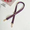 Close-up of adjustable purple nylon bag strap with gold lobster clasps and twill texture - Purple