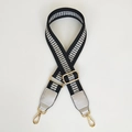 Detail of black and silver woven adjustable shoulder strap with golden metal lobster clasps - Black & Silver Geometric Grid (Silver Black + Silver Leather)