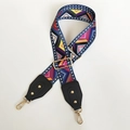 Detail of colorful geometric woven canvas strap with golden metal hooks and black leather ends - Film Grid With Black Leather and Gold Hook