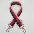Close-up of a 3.8cm wide adjustable striped canvas bag strap with gunmetal swivel hooks - Black & Red Stripe (Gunmetal Hook)