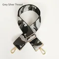 Macro shot of grey camouflage bag strap with silver thread weave and gold hardware - Grey & Silver Thread