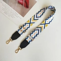 Close-up of geometric pattern strap with gold metal hooks and leather reinforcement - White Pink and Black Leather Accent