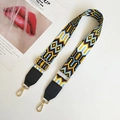 Detail showing the colorful geometric ethnic pattern and golden metal swivel hook on bag strap - Yellow White and Black Leather Accent