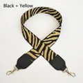 Close-up of black and yellow zebra pattern woven bag strap with gold metal spring buckles - Black+Yellow