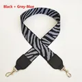 Close-up of zebra pattern handbag strap with black and grey-blue fabric and gold metal hook - Black + Gray Blue