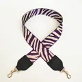 Detail of wide zebra pattern bag strap in purple and cream with gold metal hooks - Purple + Off-white