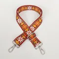 Close-up of ethnic style red woven bag strap with white daisies and silver metal clasps - Red Geometric A70 (Silver Hook)
