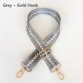 Close-up of gray woven jacquard shoulder strap with white patterns and gold hardware - Grey + Gold Hook