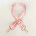 Detail of adjustable pink nylon bag strap with white chevron patterns and gold hooks - Pale Pink + Gold Hook