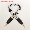 Detail of wide white and silver geometric strap with gold-tone hardware and black leather - White & Silver Thread