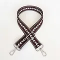 Close-up of coffee brown jacquard bag strap with white V-pattern and silver metal clasps - Coffee + Silver Hook