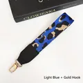 Close-up of light blue leopard print phone strap with black faux leather and gold metal clip - Light Blue + Gold Hook