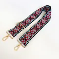 Close-up of ethnic woven pattern strap with golden metal swivel hooks and adjuster - US 12