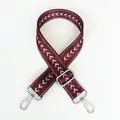 Macro detail of adjustable purple nylon shoulder strap with silver metal hooks and arrow pattern - Purple + Silver Hook