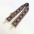 Close-up of ethnic geometric weave bag strap with golden swivel hooks and adjustable buckle - US 13