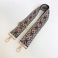 Detail view of ethnic jacquard strap with gold metal lobster clasps and geometric pattern - US 15