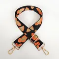 Detail of adjustable leopard print bag strap with orange pattern and gold metal hooks - Orange Black Gold Leopard + Gold Hook