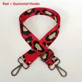 Detail of red leopard print wide bag strap with gunmetal swivel hooks and adjustment buckle - Red + Gunmetal Hook
