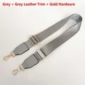 Detail of adjustable gray nylon strap with gold metal hooks and gray leather accents - Grey + Grey Leather + Gold Hook