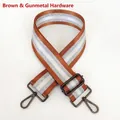 Detail of brown bag strap with silver stripes and gunmetal metal hooks on white background - Brown + Gunmetal Hook