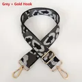Macro shot of grey leopard pattern guitar strap with shiny gold swivel hooks and buckle - Grey + Gold Hook