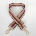 Close-up of brown striped adjustable fabric bag strap with golden metal swivel hooks - Brown + Gold Hook