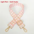 Close-up of light pink houndstooth wide strap with golden metal swivel hooks and adjuster - Light Pink + Gold Hook