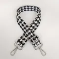 Close-up of houndstooth jacquard strap with silver metal swivel hooks and adjuster - Black & White + Silver Hooks