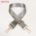 Detail view of light grey nylon shoulder strap with gold-tone lobster clasps and buckle - Light Gray