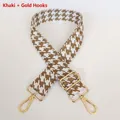 Detail of khaki houndstooth bag strap with thick webbing and gold metal hooks - Khaki + Gold Hook