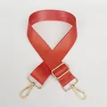 Detail of adjustable orange nylon shoulder strap with golden metal lobster clasps - Orange