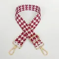 Detail of rose red houndstooth woven wide bag strap with gold metal swivel hooks - Rose Red + Gold Hook