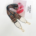 Dettaglio di un'ampia tracolla in tessuto boho con motivo etnico e ganci dorati - Fiore di Vetro Pelle Bianca / Argento