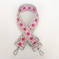 Macro view of thickened canvas strap with beige and rose red geometric diamond pattern - Pattern B10 + Silver Hardware