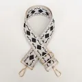 Macro view of geometric jacquard bag strap with polished gold-tone metal clips - Pattern B12 + Gold Hardware