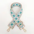 Detail view of woven guitar strap with turquoise diamond pattern and gold hook - Pattern B13 + Gold Hardware