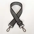 Detail of adjustable black and white silver arrow pattern bag strap with gunmetal hooks - Silver Arrow & Gunmetal Hook