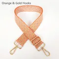 Detail of adjustable orange geometric jacquard canvas strap with golden metal carabiner hooks - Orange + Gold Hook