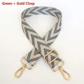 Close-up of green and beige herringbone wide strap with polished golden lobster clasps - Green + Gold Hook