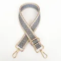 Detail of adjustable canvas strap with grey herringbone pattern and gold metal clasp - Beige Edge Gray + Gold Hook