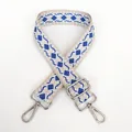 Macro detail of beige canvas bag strap with blue diamond jacquard and silver hardware - Beige Base White Blue + Silver Hook