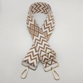 Detail view of woven geometric bag strap with premium gold metal lobster clasps - White Base Brown + Gold Hook