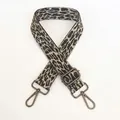 Detailed view of grey leopard print bag strap with gunmetal swivel snap hooks and slider - Grey + Gunmetal Hook