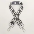 Close-up of off-white wide nylon strap with black geometric pattern and silver hook - Cream White + Silver Hook