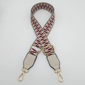 Detail view of adjustable woven shoulder strap with red and black geometric patterns - Silver Hook / Khaki Black / Off-white Leather