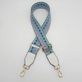 Macro view of adjustable woven bag strap with golden buckles and white leather ends - Silver Hook / Light Green Purple / White Leather