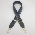 Detail of adjustable geometric blue woven strap with gold metal hooks and leather ends - Silver Hook / Dark Grey Blue / Dark Grey Leather
