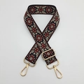 Close-up of bohemian jacquard embroidered bag strap with golden metal lobster clasps - Black Background Rust Red Beige