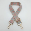 Detail of floral ethnic embroidery on beige guitar style strap with gold metal hooks - Beige Background Pink Edge Blue